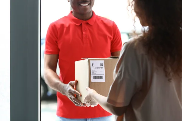 Customer receiving parcel from delivery man