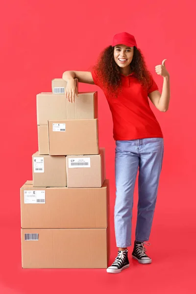 Female African American Courier Many Parcels Color Background — Stock Photo, Image
