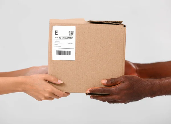 Customer Receiving Parcel Courier Grey Background — Stock Photo, Image