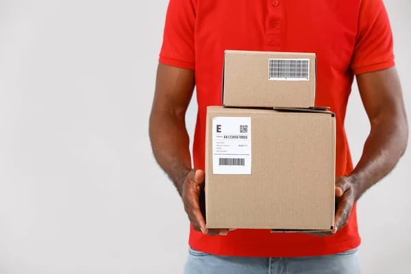 African American Delivery Man Parcels Grey Background — Stock Photo, Image