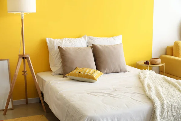 Удобная Кровать Пол Лампа Возле Цветной Стены — стоковое фото
