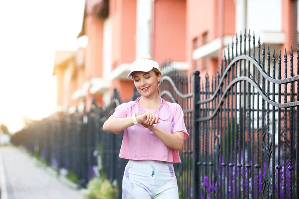 Sporty mature woman with fitness tracker outdoors