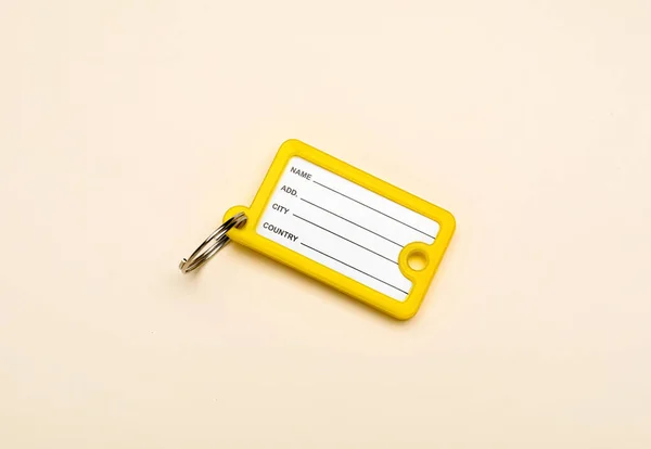 New Plastic Key Tag Beige Background — Stock Photo, Image