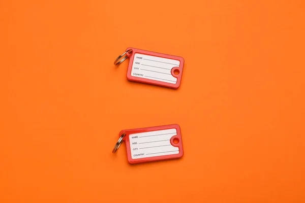 New Plastic Key Tags Orange Background — Stock Photo, Image