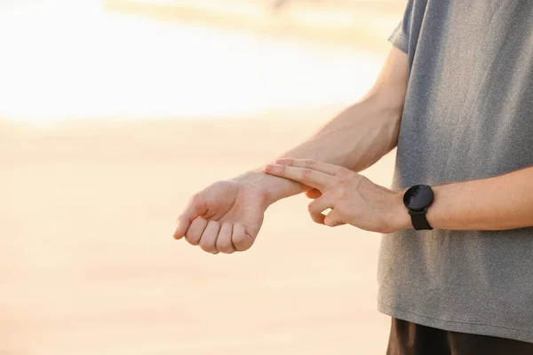 Sporty Male Runner Checking Pulse Outdoors — Stock Photo, Image