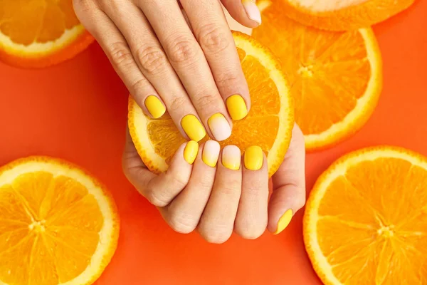 Female Hands Beautiful Manicure Orange Slices Color Background Closeup — Stock Photo, Image