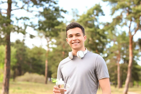 Sporty Young Man Bottle Water Headphones Park — Stock Photo, Image