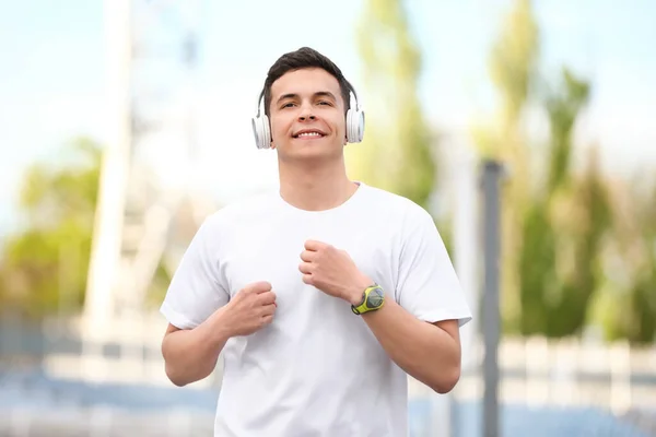 Sporty Young Man Headphones Running Stadium — Stock Photo, Image