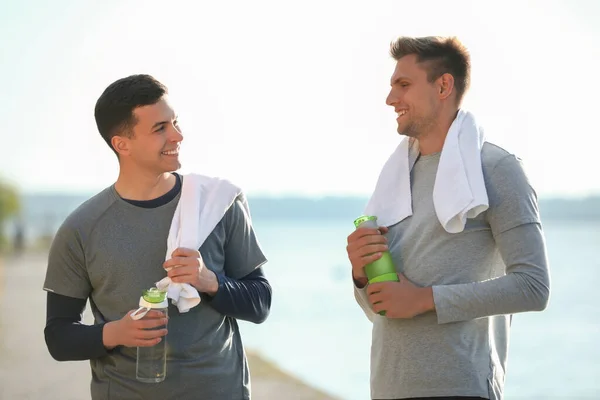 Sporty Young Men Bottles Water Running River — Stock Photo, Image