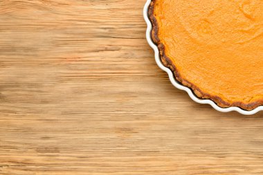 Ahşap zemin üzerinde lezzetli kabak turtası olan fırın tabağı, yakın plan.