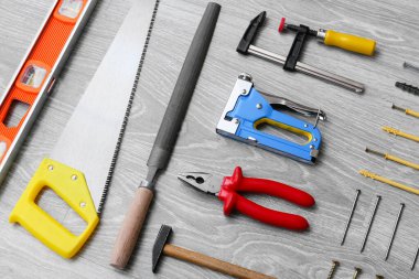 Gri ahşap arka planda mobilya montajı için araç seti, yakın plan