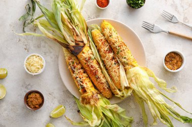 Lezzetli bir tabak Elote Meksika Sokak Mısırı ve hafif arka planda baharatlar