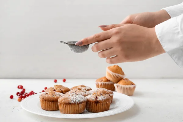 Woman Sprinkling Sugar Powder Delicious Cranberry Muffins Table — Stock Photo, Image