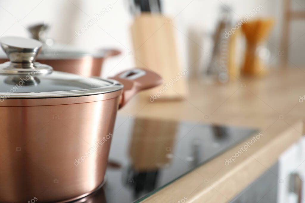 Copper cooking pot on stove in kitchen, closeup