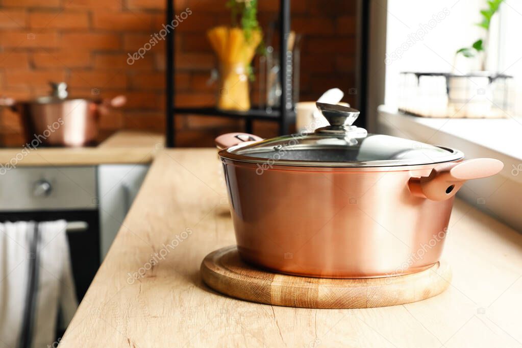 Copper cooking pot on counter in kitchen, closeup