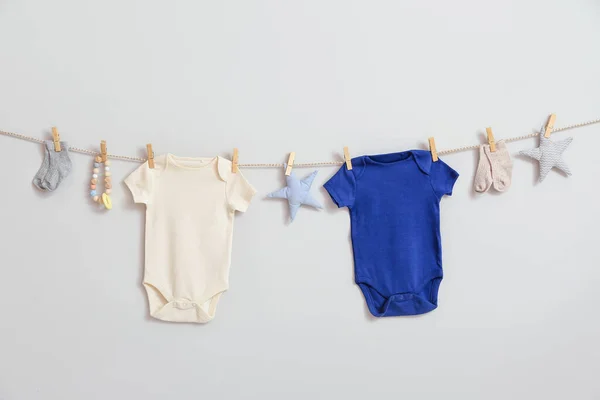 Stylish Baby Clothes Toys Hanging Rope White Background — Stock Photo, Image