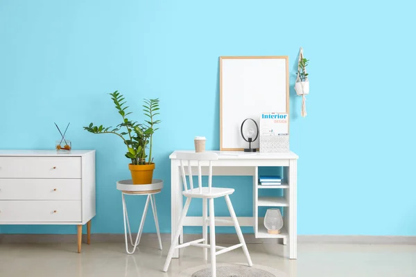 Stylish interior of living room with blank poster frame on desk with stylish chair