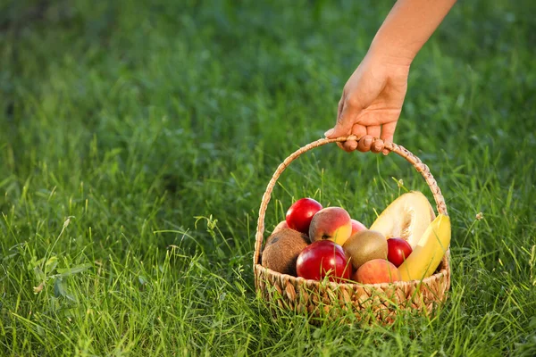 Woman Holding Wicker Basket Fresh Fruits Grass Closeup — Stock Photo, Image