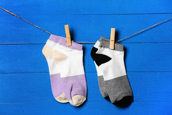 Stylish Socks Hanging Rope Blue Wooden Background — Stock Photo, Image