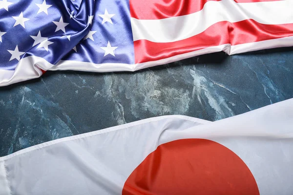 Flags of Japan and USA on grunge background