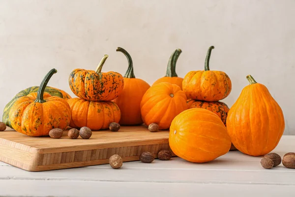 Composition Ripe Pumpkins Nutmeg Light Background — Stock Photo, Image