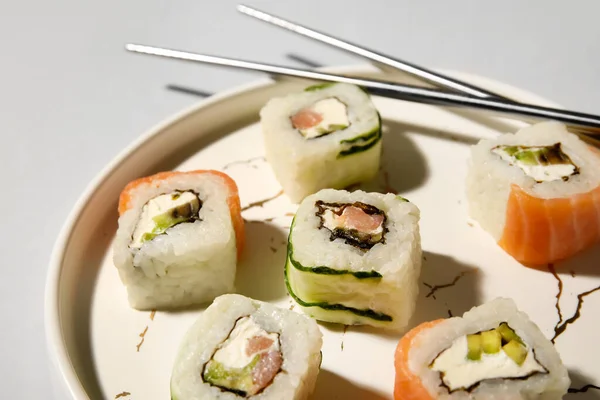 Plate Delicious Sushi Rolls Chopsticks Light Background Closeup — Stock Photo, Image