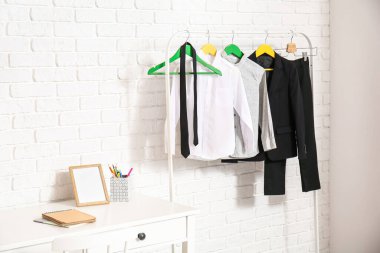 Işık duvarının yanında şık bir okul üniforması var.