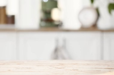 Açık ahşap masa, bulanık mutfak manzarasına karşı, yakın plan.