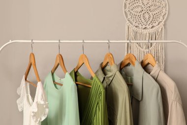 Şık koridorda asılı kıyafetlerle dizilin, yakın plan.