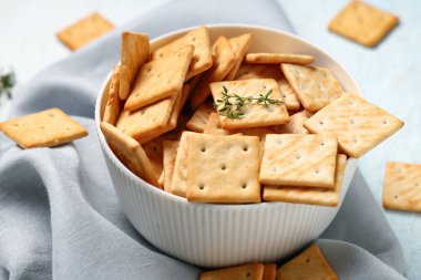 Lezzetli krakerler ve mavi arka planda kekik dalıyla kompozisyon, yakın plan.