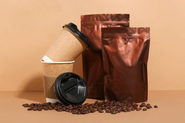 Kahve çekirdekli kahverengi torbalar ve renkli fincanlar.