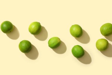 Sarı arka planda bir sürü taze limon