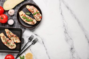 İçi doldurulmuş patlıcan, domates ve mermer kaplı sarımsak dolu fırın tabakları.