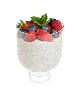 Bir bardak lezzetli chia tohumu pudingi. Nane yaprakları ve beyaz arka planda böğürtlenler.