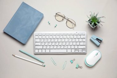 Beyaz arkaplanda klavye, fare ve kırtasiye ile kompozisyon