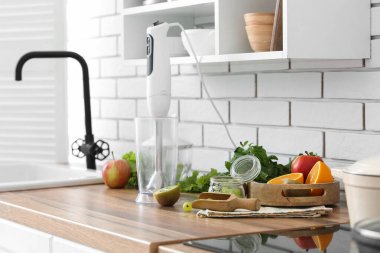 Mikser ve diğer malzemeler modern mutfaktaki masada.