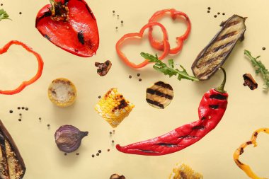 Bej arka planda lezzetli ızgara sebzeler uçuşuyor.