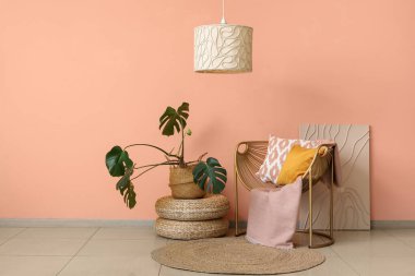 Çiçek, puf ve koltuk mercan duvarın yanında, odanın içinde.