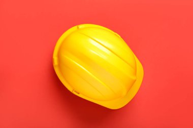 Yellow hardhat on red background