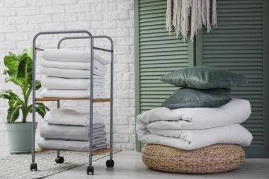 Beyaz çarşaflı, bitki ve katlanan ekranlı odanın içi