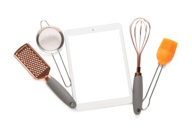 Beyaz arka planda mutfak gereçleri olan dijital tarif kitabı
