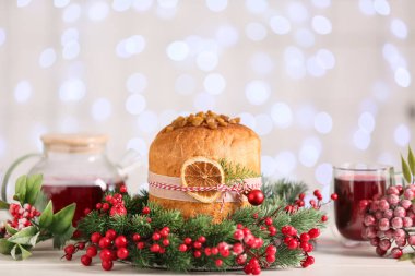Masada bulanık ışıklara karşı Noel çelengi ile Lezzetli Panettone