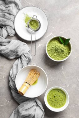 Bir kase taze kibrit çayla pudra, chasen ve elek ile gri grunge arka plan