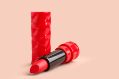 Beautiful red lipstick on beige background