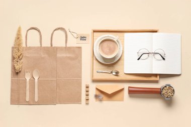 Bej arka planda bir fincan kahve, iskele filtresi ve teslimat kağıdı ile kompozisyon