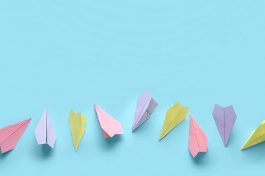 Colorful paper planes on blue background