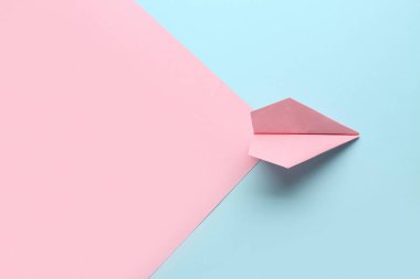 Renkli arka planda pembe kağıt uçak