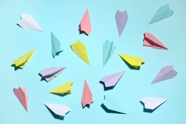 Colorful paper planes on blue background