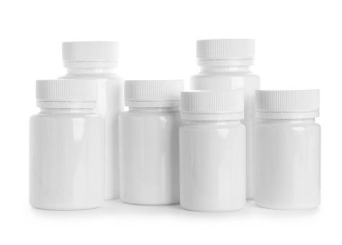 Beyaz arka planda birçok boş plastik vitamin şişesi