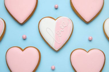 Tatlı kalp şeklinde kurabiyeler ve mavi arka planda şekerlemeler. Sevgililer Günü kutlaması